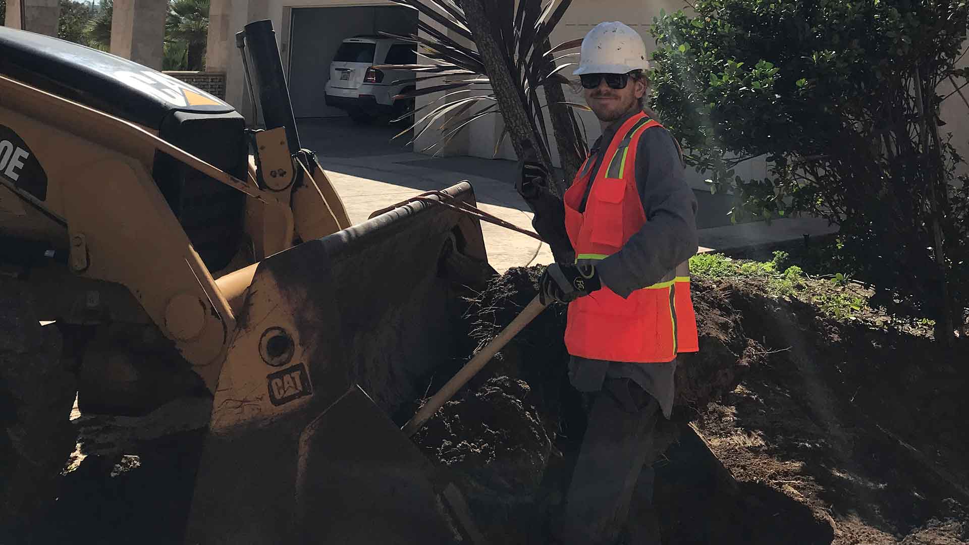 Employee working at a chipper to cut up tree branches in Rancho Santa Fe, CA.
